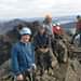 Image may contain: 3 people, people standing, mountain, outdoor and nature